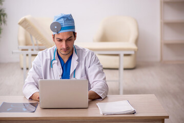 Young male doctor otologist working in the clinic