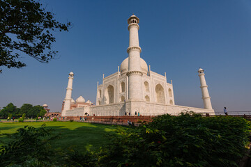 Taj Mahal historical monument at Agra India with clear blue sky and sprawling garden. An example of...