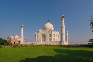 Taj Mahal historical monument at Agra India with clear blue sky and sprawling garden. An example of...