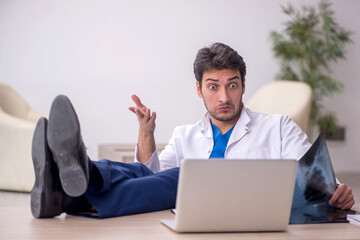Young doctor radiologist sitting at the hospital