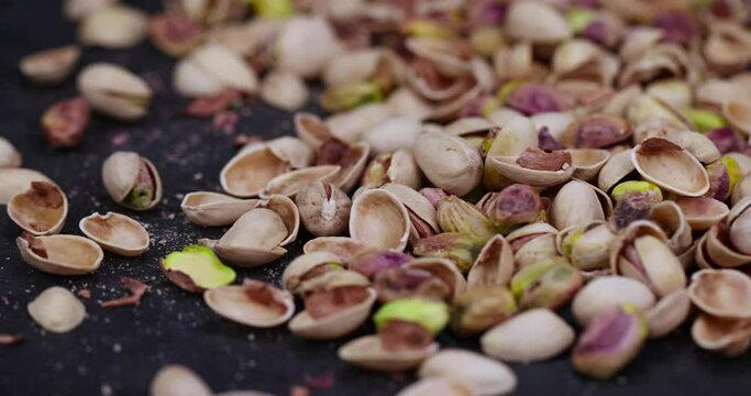 salted pistachio nuts on the table, a large number of salty and crispy pistachios close-up