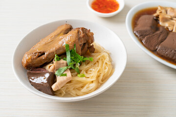 dried noodles with braised duck in white bowl