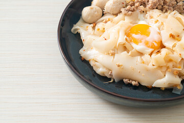 dried spicy noodles with minced pork, meatballs and egg