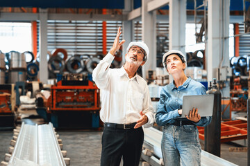 Factory manager or executive make visit metalwork manufacturing factory tour and inspect heavy...