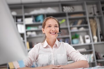 Happy young woman working with laptop computer, financial success concept.