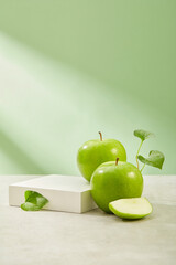 Square-shaped podium with vacant space arranged with organic green apples. Eating Green Apple...