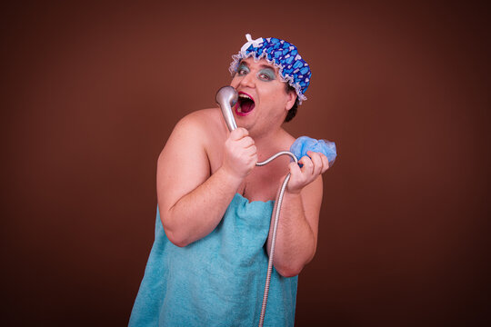 Beauty and healthy lifestyle. Funny fat man posing after a shower. Brown background.