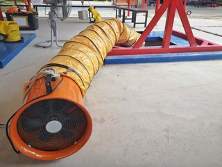 Yellow air ducts, fittings in ventilation systems of working in confined spaces, confined spaces are vertically pitted. It has a lot of depth.