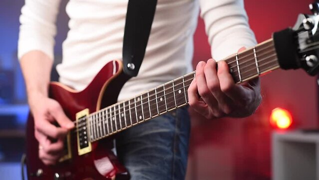 Hands of man playing electric guitar