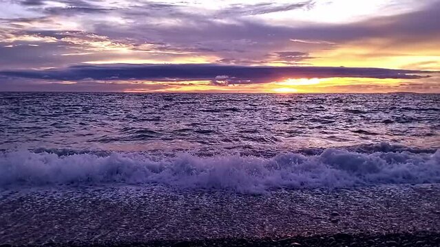 Cinematic colorful sunset over Surigao Strait seen from Looc Beach in Surigao City, Philippines. 