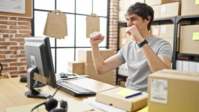 Young hispanic man ecommerce business worker looking watch relaxing at office