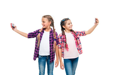 Obraz premium heartwarming friendship selfie. school children making selfie. girls children having selfie time. school friends capture fun with selfie. friendship concept. Supportive school friendship