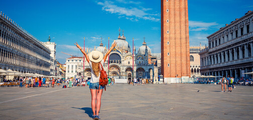 Happy traveler woman on the Piazza San Marco- Venice in Italy