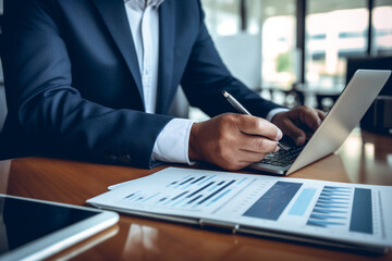 Fototapeta premium Business, finance, law concept. Man hands using tablet with visible chart or diagram. Model with suit. Office in background. Close-up view. Generative AI
