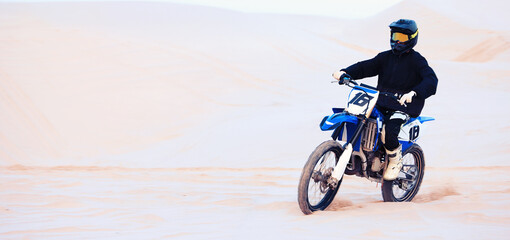 Obraz premium Sand, sports or athlete with motorcycle for action, adventure or fitness with performance for adrenaline. Sunset, desert or person on motorbike on dunes for training, exercise or race or challenge