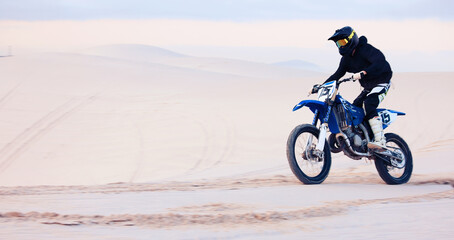 Sand, speed or athlete driving motorbike for action, adventure or fitness with performance or adrenaline. Fast, nature or sports person on motorcycle on dunes for training, exercise or race challenge