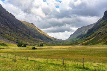 Fototapeta na wymiar Beautiful Glencoe Valley in the Scottish Highlands with high mountains and green meadows