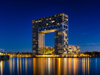 Amsterdam, Netherlands. A cityscape in the evening. A skyscraper and business center near the water...