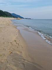 
It is a seascape with a sandy beach.