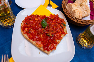 bruschetta with fresh tomato sauce and basil on heart-shaped bread