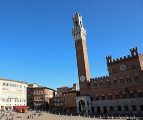Fototapeta na wymiar Siena, SI, Italy - February 20, 2023: tower called TORRE DEL MANGIA in the main square