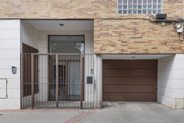 Fototapeta na wymiar Portal with brown metal fence for access to the homes