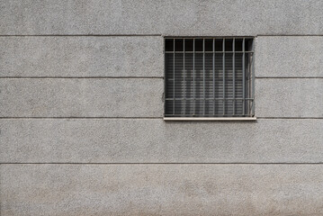 A square window with the blinds lowered