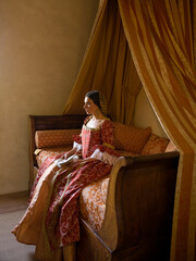 Renaissance lady on castle bed © Anneke