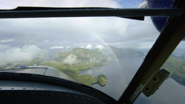 Point of View of passenger in small airplane over rain forest