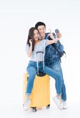 Young Couple traveler with luggage on white background. Man and girl preparing for vacation. Asian Couple traveler with luggage isolated on white