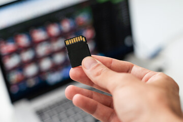 Hand holding sim card, micro sd chip