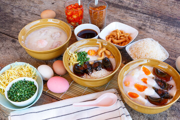Thai food Breakfast set - soft boiled egg and minced pork ball with rice porridge  with century egg and sliced liver topping by crispy noodle