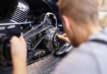 Fototapeta premium Male service man hold silver key in hand closeup. Motorcycle repair concept