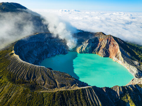 Aerial view of rock cliff at Kawah Ijen volcano with turquoise sulfur water lake at sunrise.Amazing nature landscape view at East Java, Indonesia. Natural landscape background