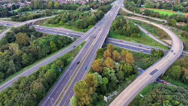 Junction 12 in Greater Manchester where outer ring road M60 intersects with M62 just at the outskirts of Manchester. Aerial Drone video. 