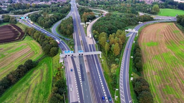 Junction 12 in Greater Manchester where outer ring road M60 intersects with M62 just at the outskirts of Manchester. Aerial Drone video. 