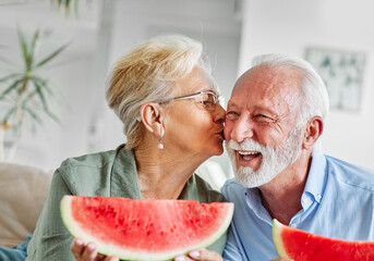 senior woman man couple love elderly watermelon fruit eating food fun togetherness summer cheerful happy smiling together enjoyment healthy eating fresh sharing