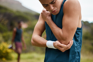 Sports man, nature and elbow pain from workout training injury or fitness running accident outdoors. Bad bruise, broken arm bone or closeup of injured athlete runner with exercise emergency in park