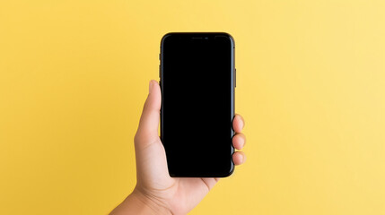 Fototapeta na wymiar Hand holding the black smartphone with blank screen