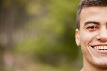 Smile, half portrait and a man in nature for fitness, exercise or a workout on bokeh. Happy, face and an athlete or person in a park for training, sport or running on mockup space for cardio
