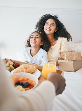 Hands, mothers day and breakfast in bed, home and happy woman with girl, gift box and kindness for love. Mom, child and person with food, brunch and present in bedroom for bonding in family house