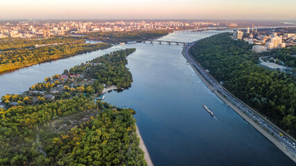 Fototapeta premium Kyiv city skyline and Dnipro river aerial drone view from above, Kiev bridges and Dnieper river islands in spring, Ukraine