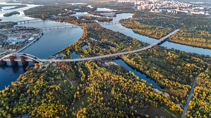 Kyiv city skyline and Dnipro river aerial drone view from above, Kiev bridges and Dnieper river islands in spring, Ukraine