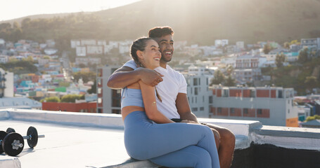 Fitness, couple and city to rest for exercise, workout or training together on a building rooftop. Happy man and woman on sports outdoor break with smile, communication or conversation in Cape Town © Kay A/peopleimages.com