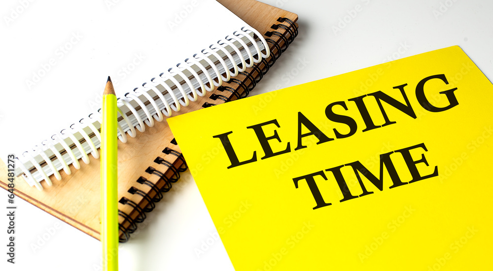 Poster leasing time text written on a yellow paper with notebook