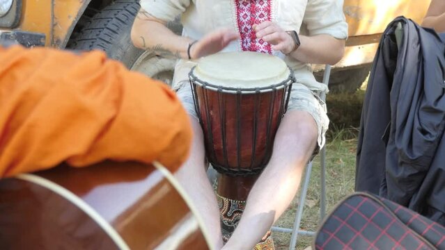 People play guitar and drums at a picnic