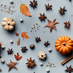 Seamless pattern with pumpkins, dry autumn leaves, anise stars and cinnamon sticks, pumpkin spice ingredients, flat lay photo on muted blue background, repeat texture