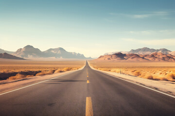 Straight road in the desert with mountain backdrop