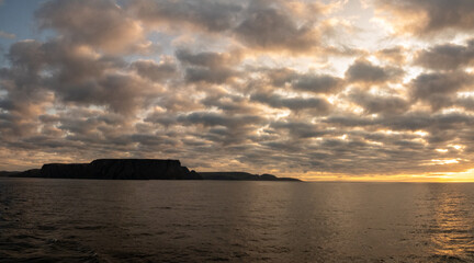 Midnight sun over the Nordkapp (North Cape), view froma ship, Troms of Finnmark, Norway. commonly referred to as the northernmost point of Europe