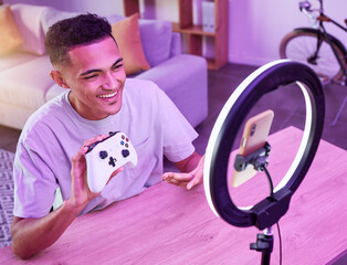 Review, live streaming and man gamer talking of console controller on social media for connection on vlog. Ring light, influencer and content creator or person speaking on internet show as host